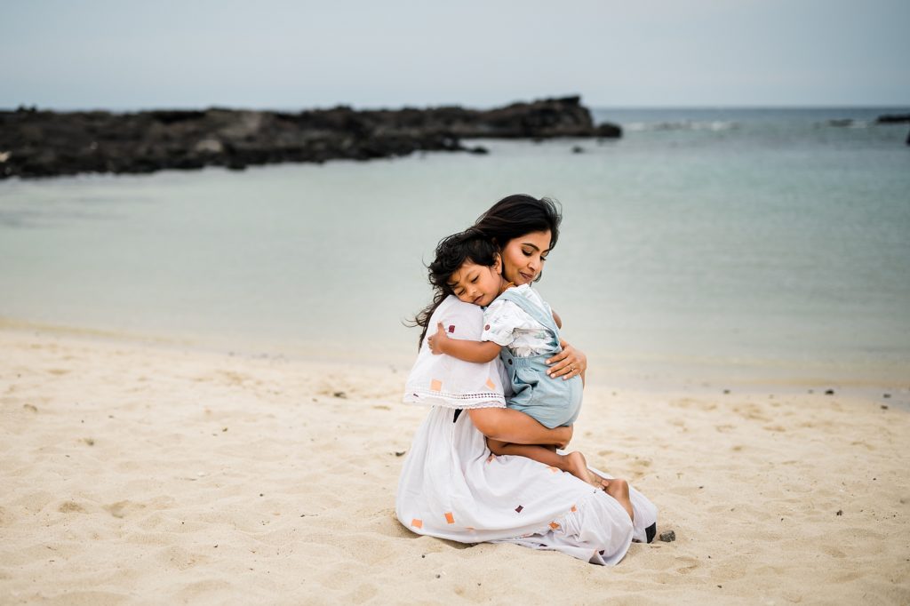 mom and son embracing each other at Hawaii beach