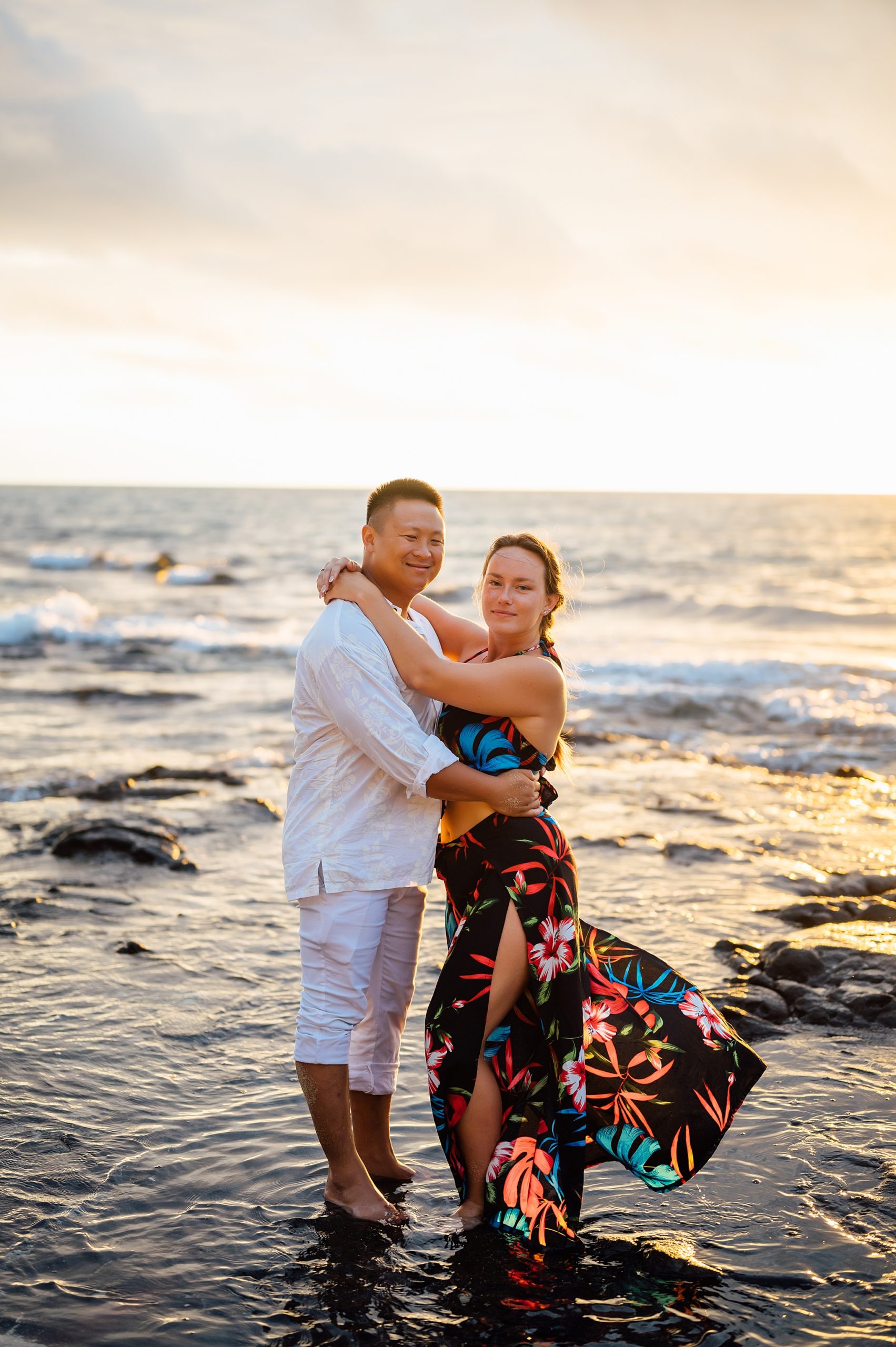 couple embracing at the beach during their honeymoon session