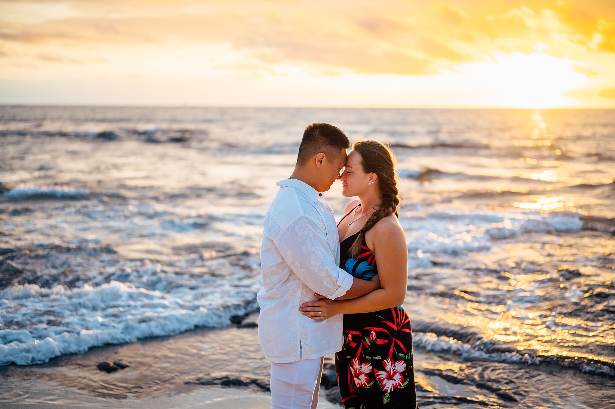 beautiful sunset behind the couple at a beach in Hawaii