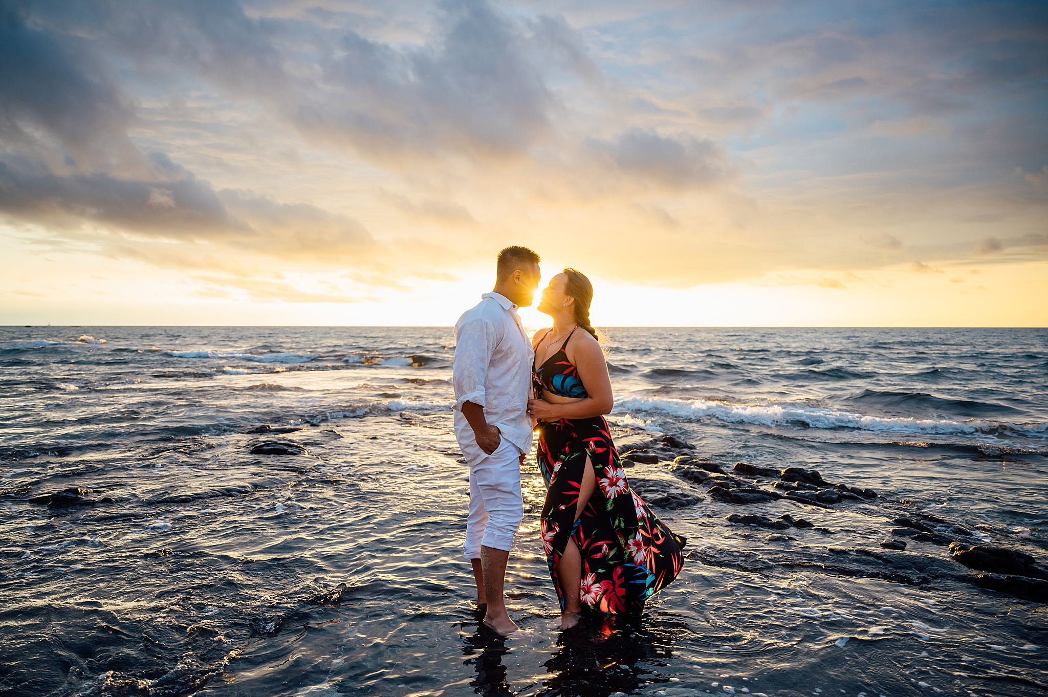 couple standing on the water at a beach in Hawaii