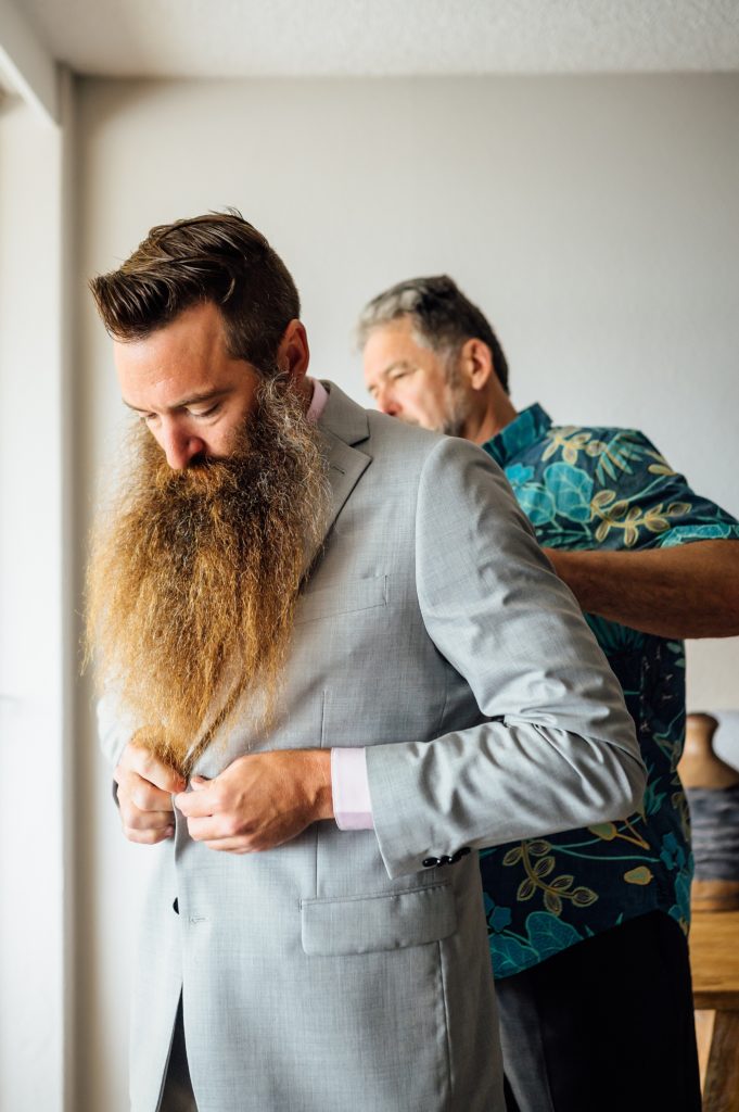 groom getting ready with dad for his wedding 