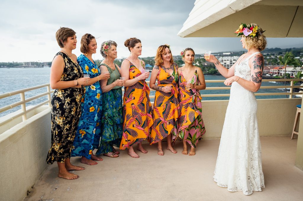 bride making a toasts with bridesmaids during her Kona wedding