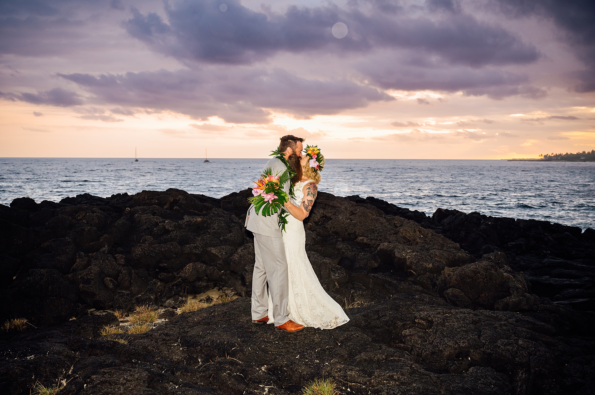 bride and groom kissing on the lava rocks in Kona, Hawaii