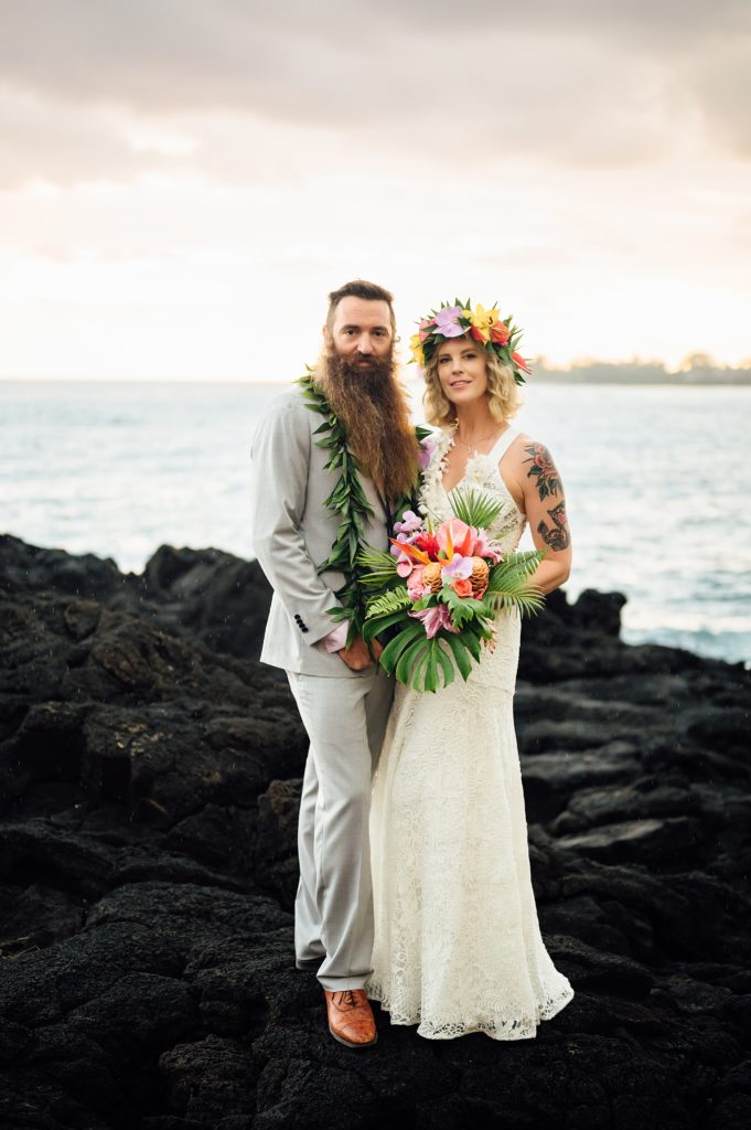 newlyweds on the lava rocks during their wedding in Kona