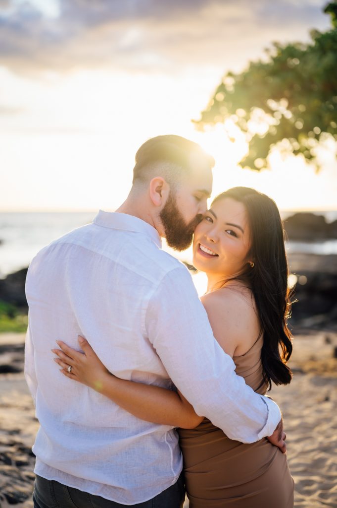 engagement photo of couple under stunning Hawaii sunset