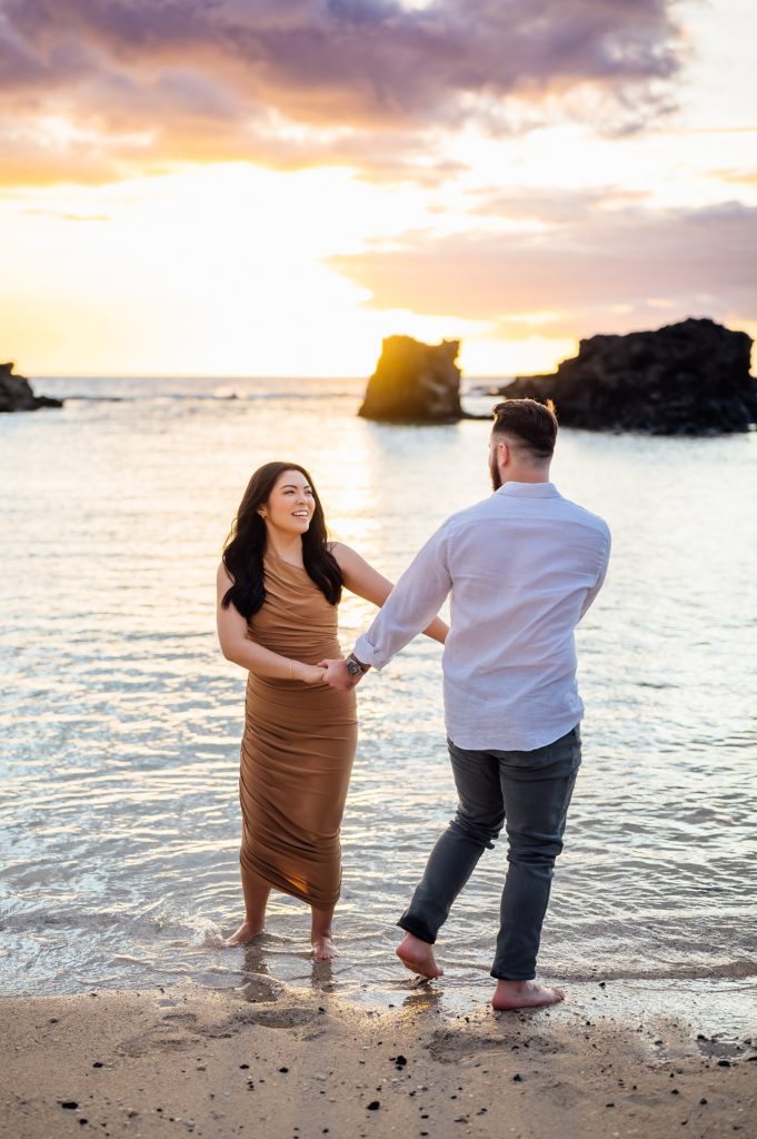 couple enjoying their engagement session at Hawaii beach