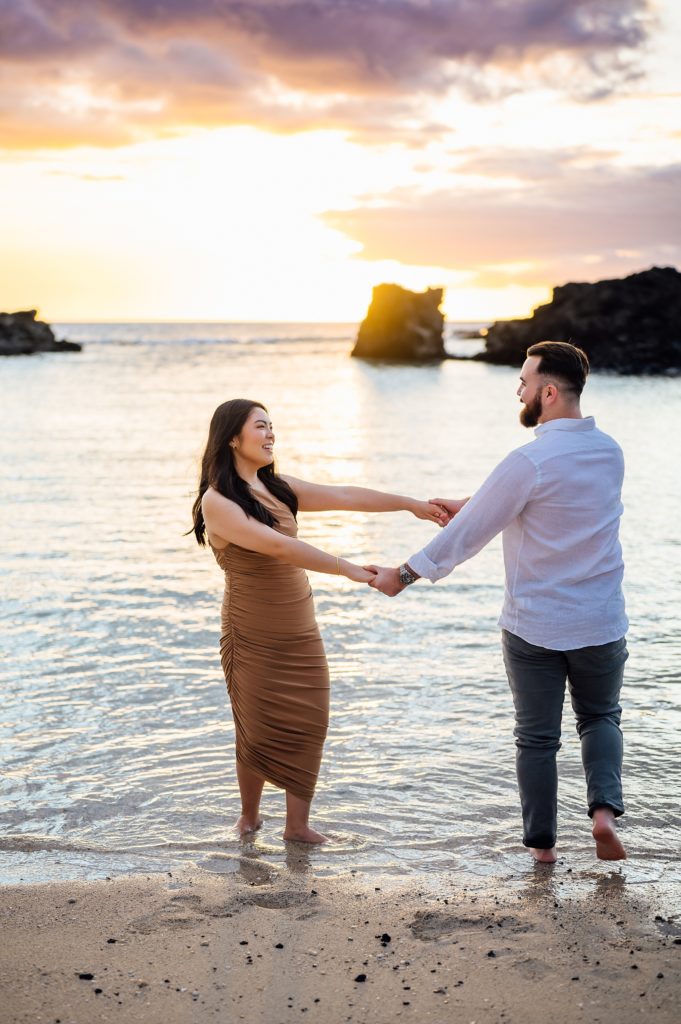 couple enjoying their engagement session at Hawaii beach