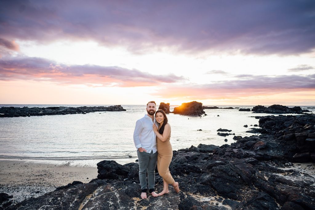 couple standing on the lava rocks at Hawaii beach