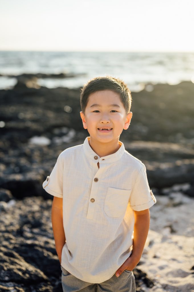 boy at the beach during sunset by Hawaii photographer
