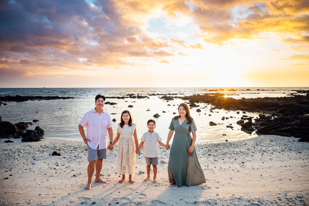 beautiful family portrait during sunset at Hawaii beach