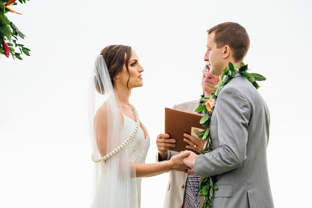 bride and groom holding hands during their Hawaii wedding ceremony 