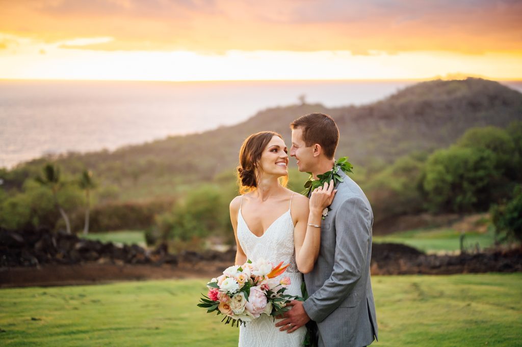 stunning sunset behind the newlyweds during their Hawaii wedding