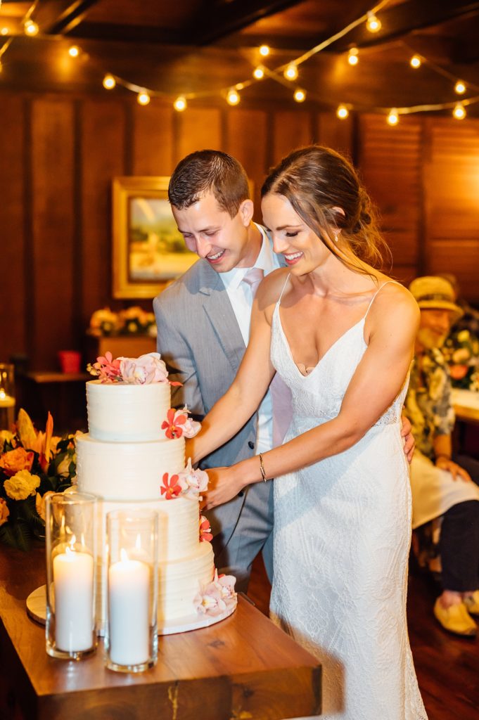 bride and groom slicing their wedding cake