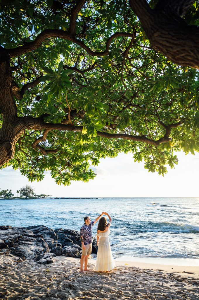 couple twirling at the beach by Hawaii photographer