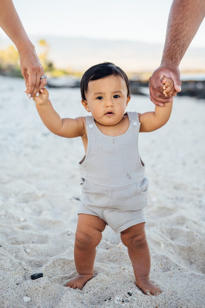 photo of a cute baby at a beach during summer