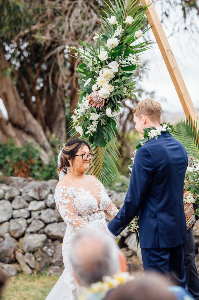 bride and groom holding hands during their Hawaii wedding ceremony