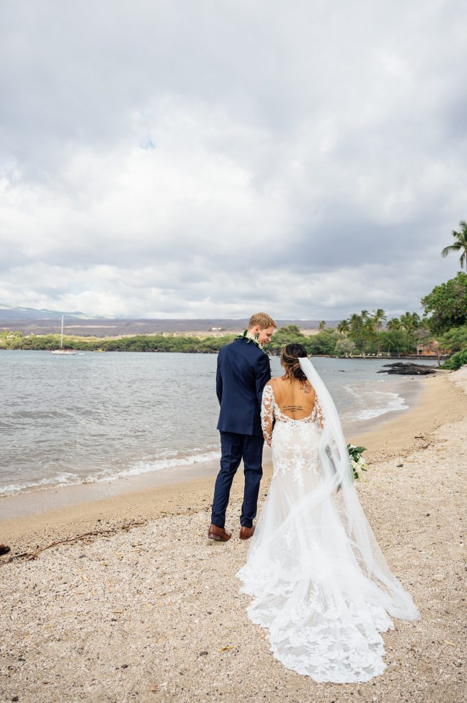 bride and groom walking at Puako beach in Hawaii