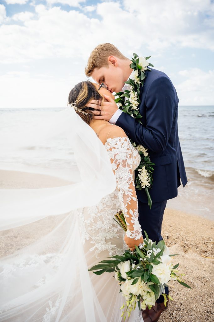 bride and groom kissing at Puako beach in Hawaii