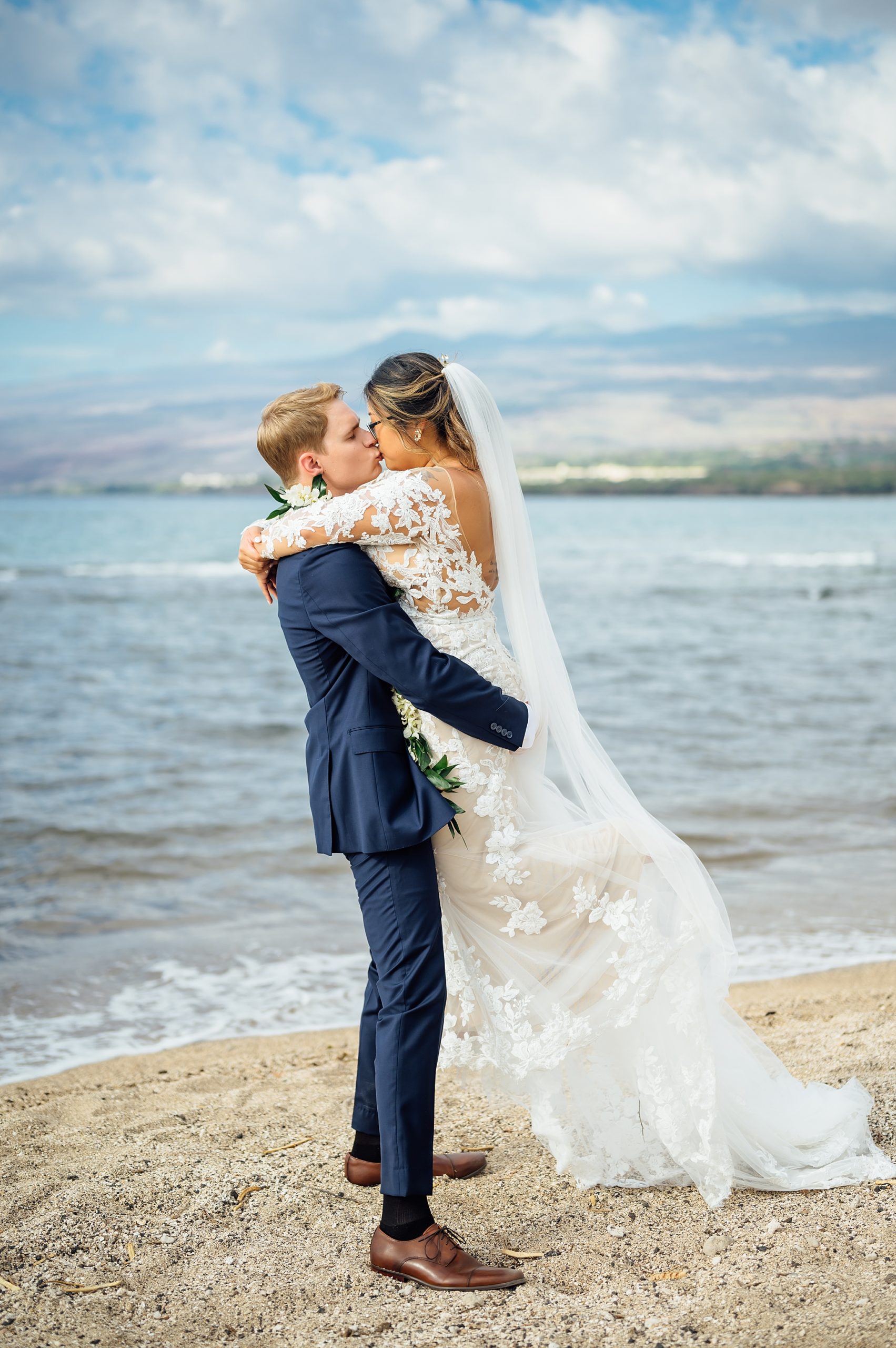 couple kissing at Puako beach during their wedding