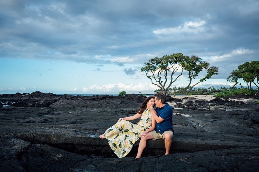 couple about to kiss on the lava rocks in Kona