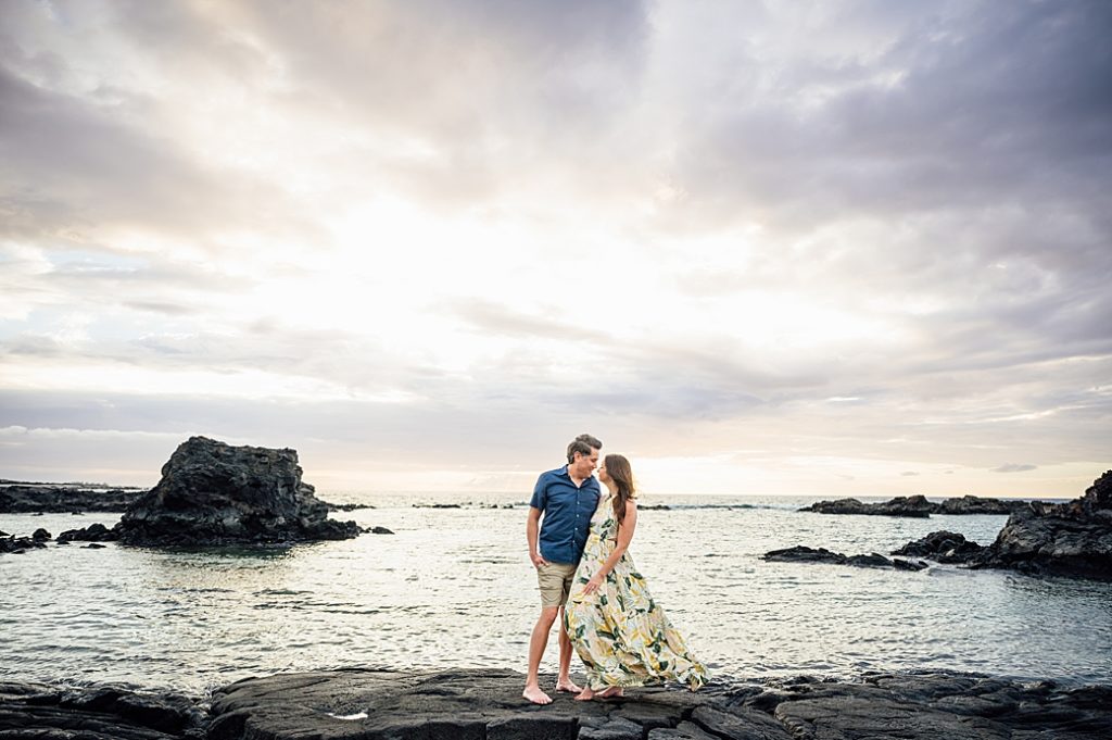 engagement photo of the couple standing on the lava rocks 