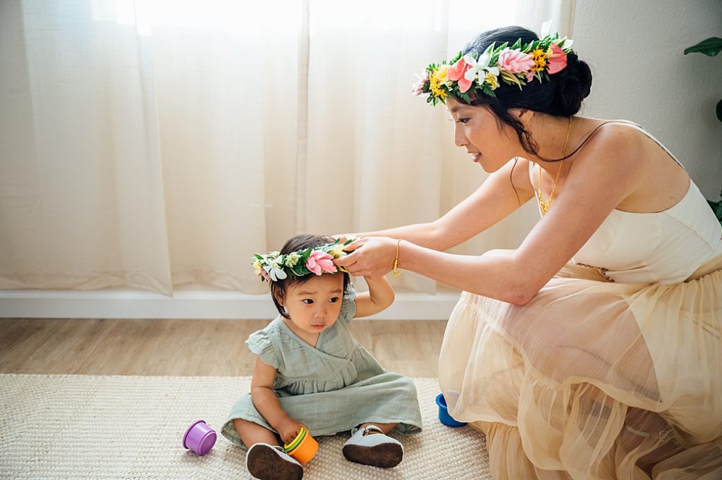 bride putting on the floral crown to her daughter