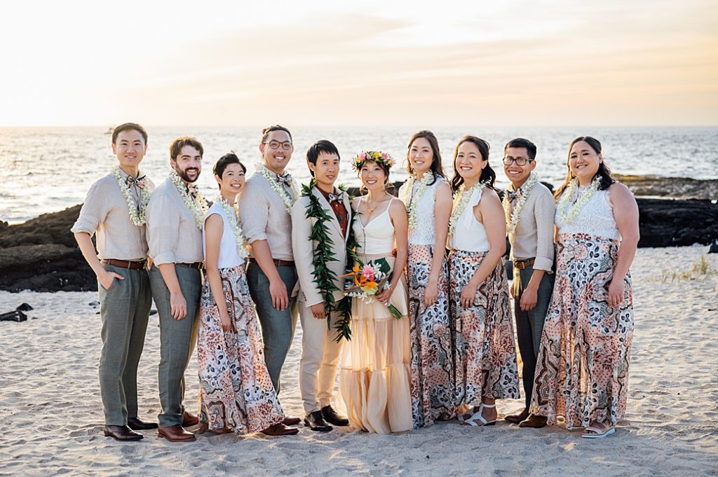 newlyweds with their wedding party by wedding photographer