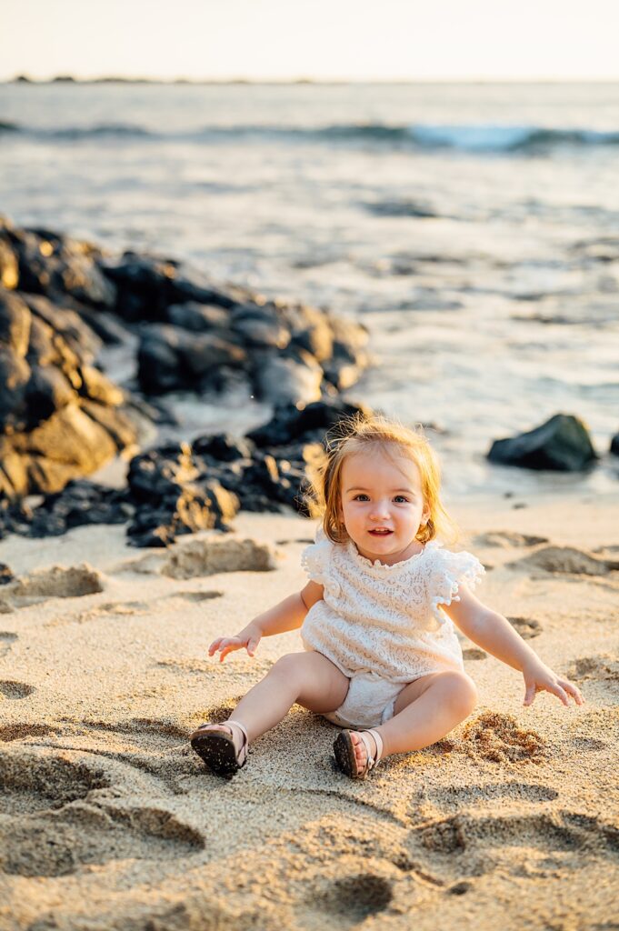 little girl sitting on the sand by Big Island photographer